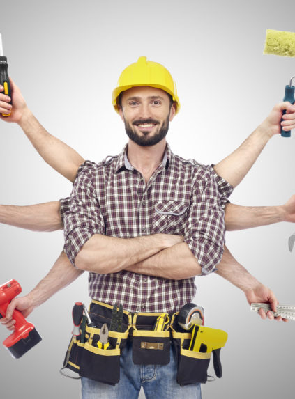 Cheerful carpenter looking at camera with tolls in six hands